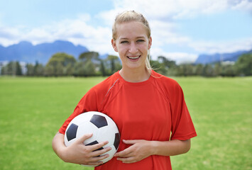 Woman, field and portrait with soccer ball, happy and football pitch for match, competition or game. Fitness, practice and ready for training, outdoor and exercise for athlete, strong and sport