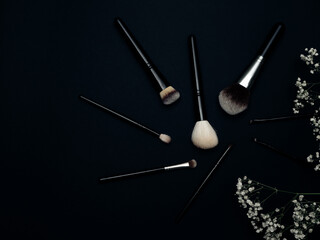 Makeup brushes on a black background