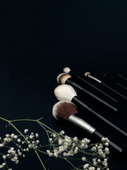 Makeup brushes on a black background