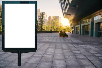 White billboard in the foreground with a square background in the modern city. Exceptional template, ideal for advertising, communications and texts.