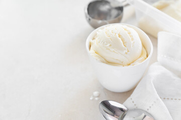 Vanilla ice cream in white cup, marble background