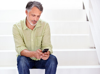 Business, man or phone on stairs in office for social network, download digital app or contact in agency. Mature entrepreneur typing on smartphone, reading mobile notification or search news on steps
