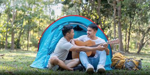 Male gay couple asian traveling with tent camping outdoor and various adventure lifestyle hiking active summer vacation