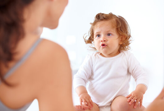 Bonding, mom and baby talking in home together with love, happiness and development of child, Kid, speaking and relax with mother in bedroom or morning with curious, learning and growth of toddler
