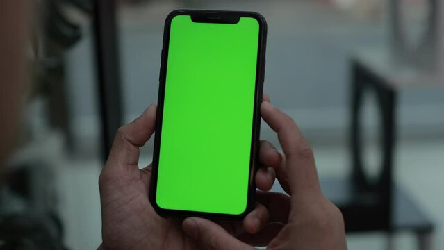 Phone in hand, smartphone green screen, hand holding mobile phone 