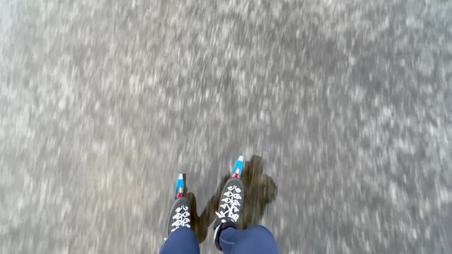 High quality footage of legs and feet of person ice skating on a frozen lake in winter near Sneek, Friesland, the Netherlands