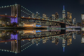 view of the brooklin bridge at night with reflections. manhattam skyline, brooklyn bridge. New York...