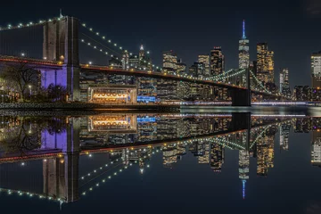 Tuinposter view of the brooklin bridge at night with reflections. manhattam skyline, brooklyn bridge. New York City © servando