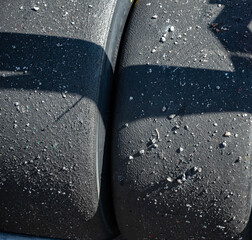 Detail of the texture of the slick tires dirty with pebbles from the circuit © Adolf