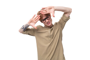 young handsome red-haired man in glasses and a shirt on a white background