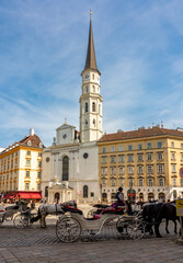 Naklejka premium Horse carriages on St. Michael square (Michaelerplatz), Vienna, Austria