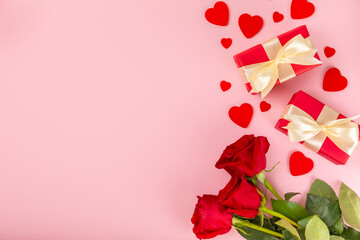 Valentine's Day concept.Valentine's Day background. Gifts and a bouquet of roses on a pink background. Flatley.Valentine's day celebration