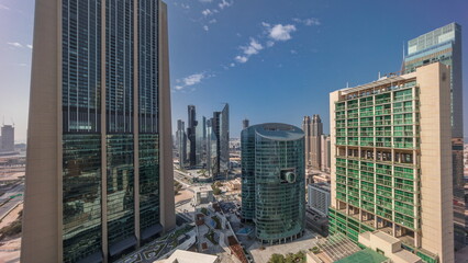 Dubai international financial center skyscrapers with promenade on a gate avenue aerial all day timelapse.