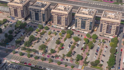 Aerial view of many colorful cars parked on parking lot with lines and markings for parking places...