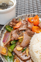angle view beef with sweet pepper and onion and rice and soup at vertical composition