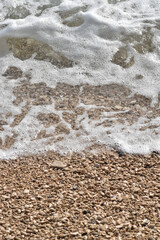 Pebble Shoreline with Crashing Waves and Clear Water