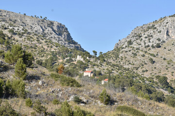 Fototapeta na wymiar Remote Mountain Houses Nestled in Mediterranean Hills