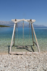 Wooden Swing On The Beach
