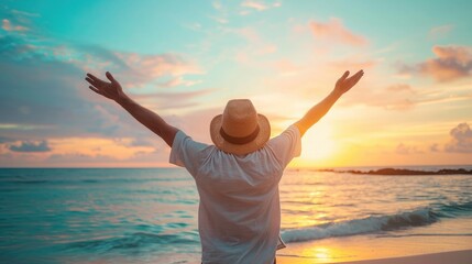 Back view of happy excited man raising arms up to blue sky - Hipster winner traveler enjoying summer sunset at the beach