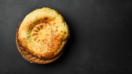 Pita bread on dark background. Arabic, Lebanese bread, traditional food. Close-up, dark background.