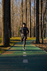 Mature man running in the park with headphones