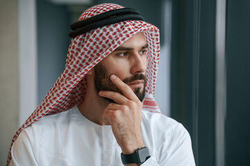 Close up portrait. Successful Muslim businessman in traditional outfit in his office