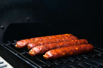 sausage with edible collagen casing is being cooked using the smoking method
