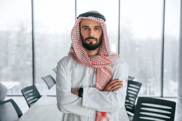 Successful Muslim businessman in traditional outfit in his office