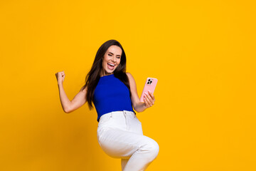 Photo of shiny lucky lady dressed blue top online sale shopping modern device empty space isolated yellow color background