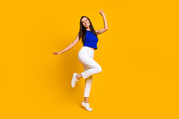 Fototapeta na wymiar Full length photo of cheerful pretty lady dressed blue top enjoying discotheque empty space isolated yellow color background
