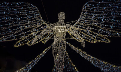 Flying angel Christmas decoration led lights display. Dramatic view of the traditional Christmas decoration lights hanging above Regent Street during dusk, The Spirit of Christmas, Light Festival.