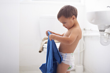 Home, morning and child dressing with clothes and learning to style or change into shirt. Kid,...