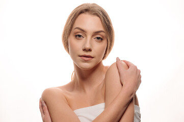 Beauty portrait of a beautiful girl on an isolated white background. Skin care concept. Cosmetology