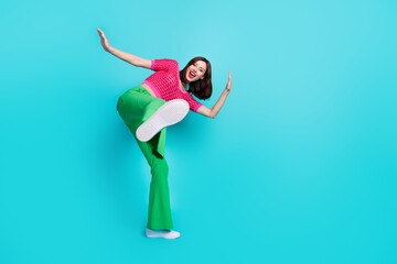 Full size photo of good mood crazy girl wear pink knit top green trousers showing you sole of shoe...