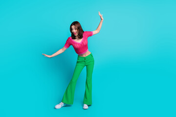 Full size photo of ecstatic lovely girl wear pink knit top green trousers look down at offer empty space isolated on blue color background