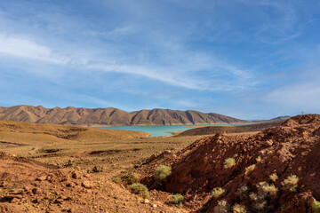 Turquoise blue water in Barrage Al-Hassan Addakhil in dry nature near Errachidia in Morocco.