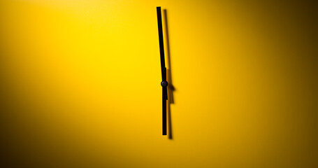 Abstract clock - modern clock hands showing time under dramatic light on a yellow background.