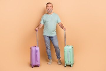 Full size photo of cheerful nice person have good mood hold suitcase isolated on beige color background