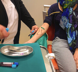 Nurse draws a blood sample for a medical test
