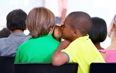 Little boys, whisper and classroom in ear for secret, gossip or communication at school. Male...