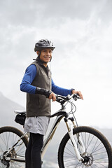 Smile, portrait and a man with a bike in nature for cycling, fitness and training in nature. Happy,...