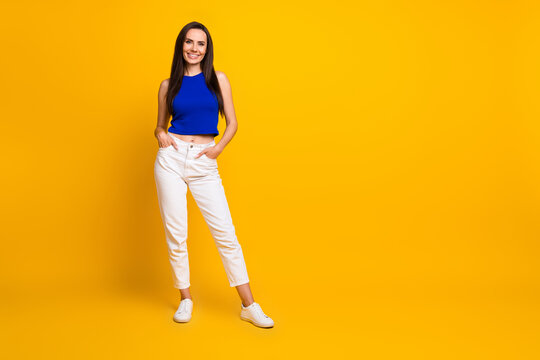Full length photo of positive shiny lady dressed blue top smiling empty space isolated yellow color background