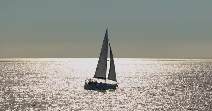 Aerial view Yacht sailing on opened sea. Yachting video. Yacht from above. Yachting at windy day