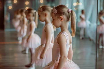 Gordijnen Group of little girl dancing ballet in a dance studio © Kien
