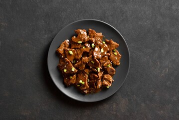 Asian style beef with soy sauce, green onion and sesame seeds