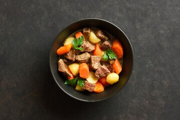 Beef stew with potatoes, carrots and greens
