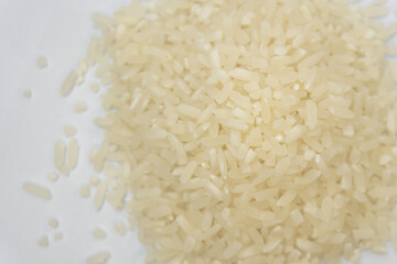 Stacked white rice on a bright white background.
