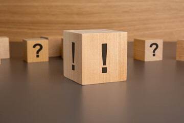 Close-up: a wooden cube with an exclamation mark lies on the table, small wooden cubes with...