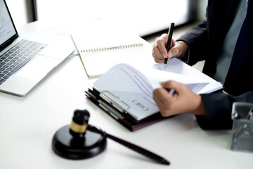 lawyer write drafts a legal document at a desk with stationery