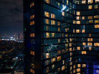 Fototapeta premium Istanbul's glass and concrete skyscrapers, home to offices, hotels, and residential complexes at night. Aerial drone view